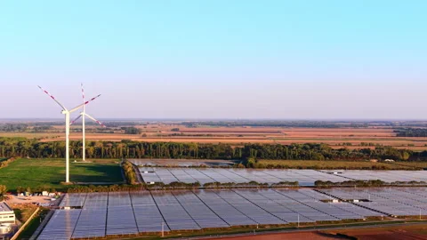 Solar panel array and wind turbines in rural landscape 스톡 동영상 348016262