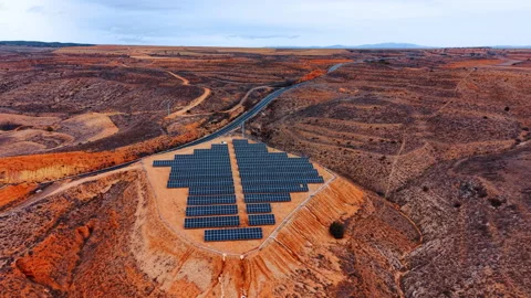 Solar panel array in arid landscape near rural road Stock-Footage 330789352