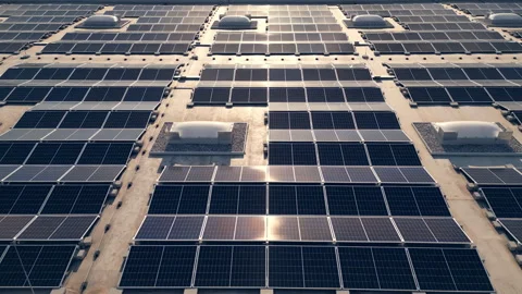 Solar panel array on building roof during sunset aerial view Stock Footage 278672542