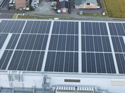 Solar Panel Array Covering a Large Building Roof Stock Photos