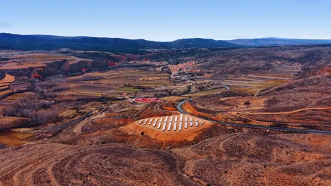 Solar panel array on hill overlooking small Spanish village Video stock 332167312