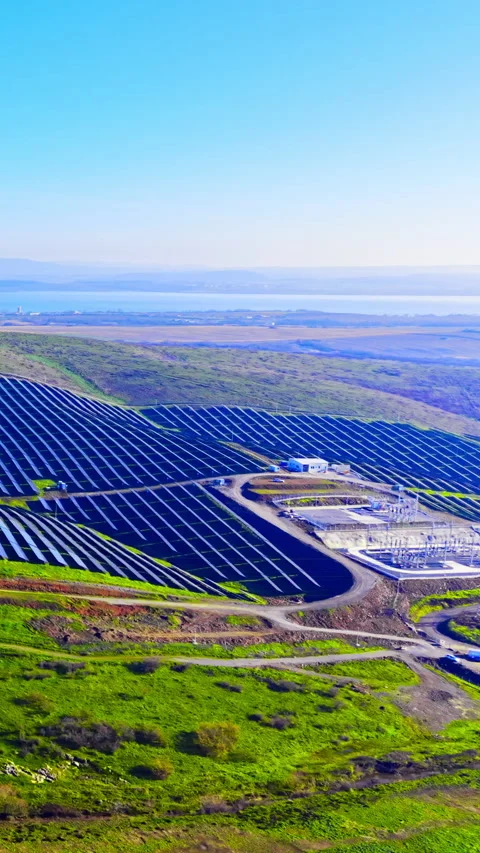 Solar panel array on hills near coastal area Vertical video. Stock Footage 332347139