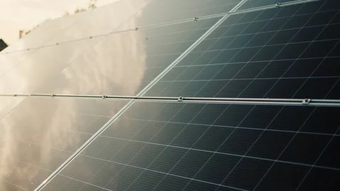 Solar panel array reflecting cloudy sky and sunlight on a sunny day clean e.. Stock-Footage 334934310