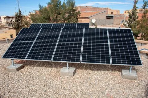 Solar panel array on rooftop generating renewable energy from the suns rays Stock Photos