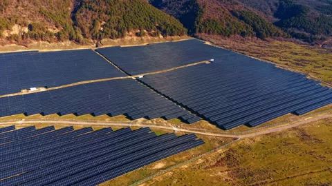 Solar panel array rows on mountain slope aerial view Stock-Footage 330789259