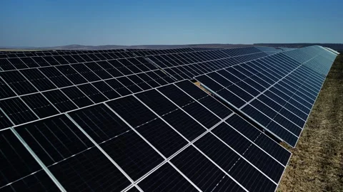 Solar panel array in a vast field with multiple rows of photovoltaic modules Stock-Footage 332893761