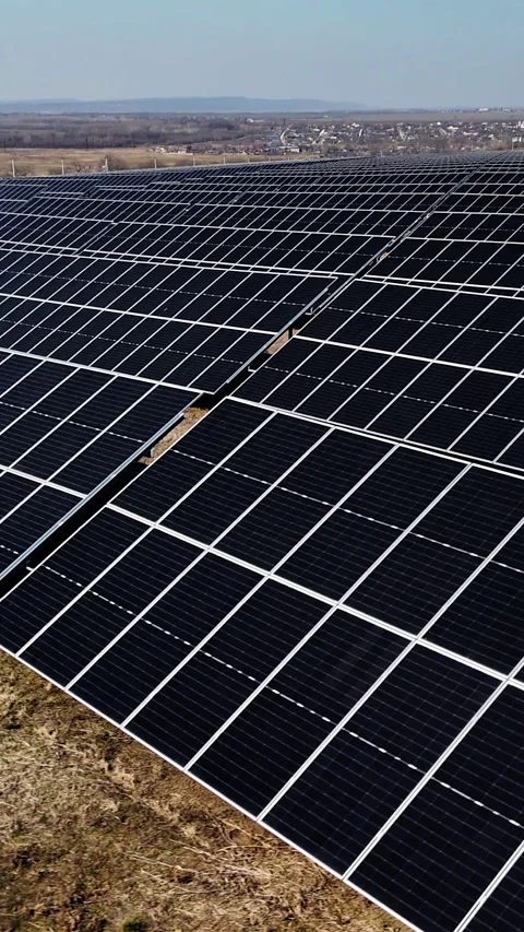 Solar panel array viewed from above, showcasing rows of photovoltaic cells Video stock 337998466
