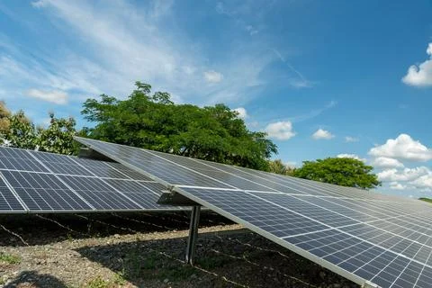 Solar panel arrays with clouds and blue skies in the background. Stock Photos