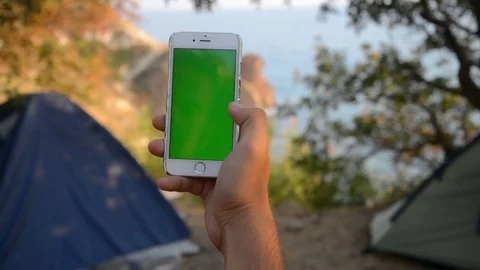 The solar panel attached to the tent. The man sitting next to mobile phone Video stock 79409531