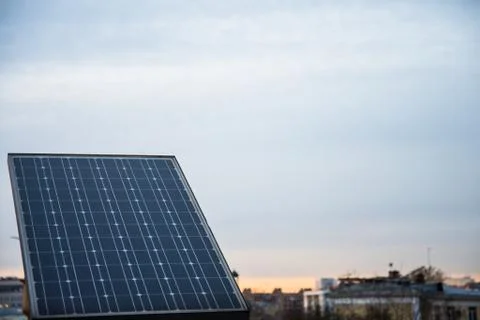 Solar panel on the background of the city. Stock Photos