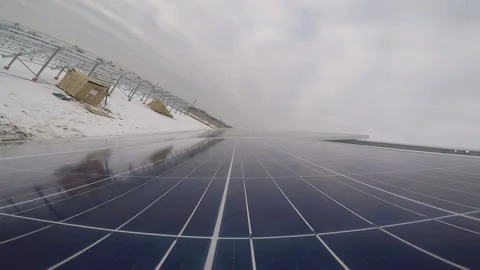 Solar panel is being put on a mounting rack at a power station, winter snow Stock Footage 160810839