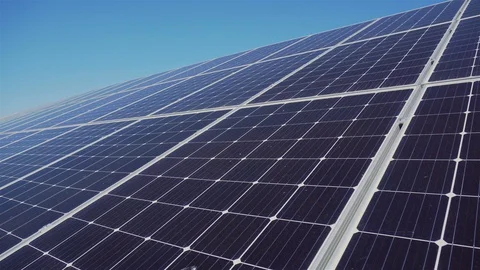 Solar panel cells close up against blue sky at peak of electricity production Stock Footage 128170196
