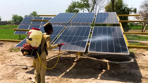 Solar panel cleaning by a farmer Stock Footage 292920607