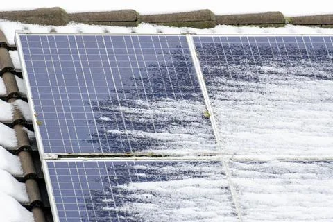 A solar panel covered in snow Stock Photos