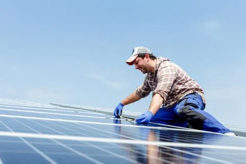 Solar panel energy. Electrical engineer man is working in solar station on ro Stock Photos