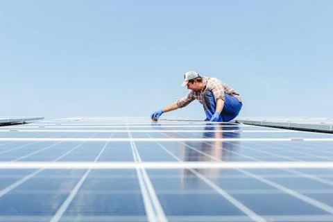 Solar panel energy. Electrical engineer man is working in solar station on ro Stock-Fotos