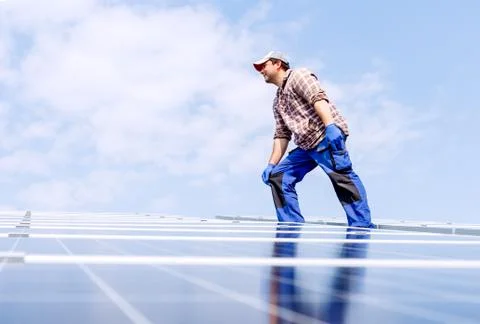 Solar panel energy. Electrical engineer man is working in solar station on ro Stock Photos
