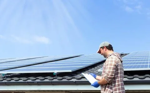 Solar panel energy. Electrical engineer man is working checking documents in  Stock Photos