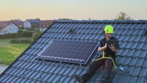 Solar panel engineer using technology to install panels, motion graphics Stock Footage 233676227