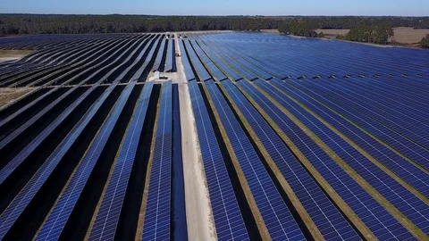 Solar Panel Farm aerial tracking bulldozer through rows Stock Footage 101254076