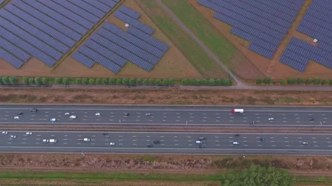 Solar panel farm and dutch highway traffic aerial view Stock Footage 342811174