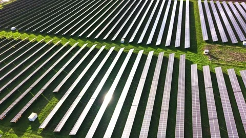 Solar panel farm captured from above during daytime in green landscape Stock Footage 325089971