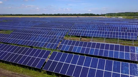 Solar panel farm generating electricity for national grid with a motion graphic Stock Footage 155778739