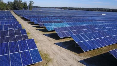 Solar Panel Farm low aerial rows of panels Stock Photos