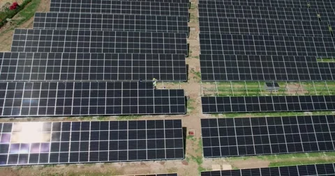 A solar panel field with a man working on it. Scene is one of hard work and d Stock-Footage 344915967