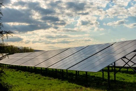 Solar panel field under dramatic cloudy sky landscape 스톡 사진