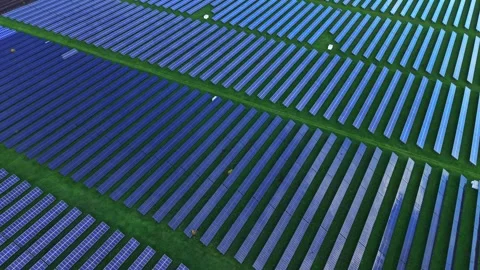 Solar panel field viewed from above at sunset in a green landscape Stock Footage 325090826