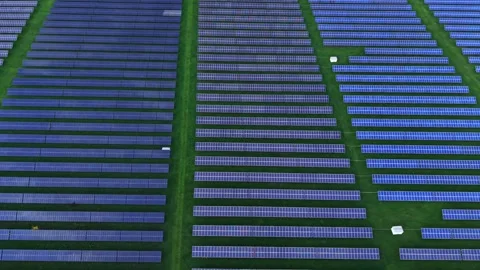 Solar panel fields cover vast area in aerial view during sunny day Stock Footage 325090676