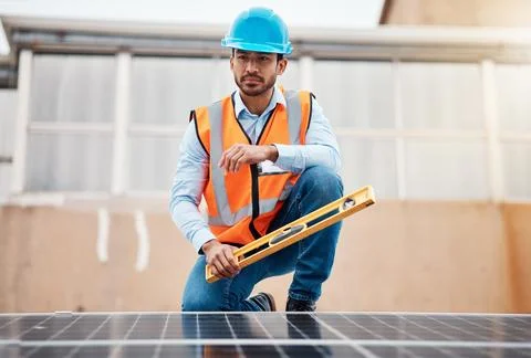 Solar panel, grid and engineering with man on roof top for renewable energy Stock Photos