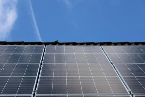 Solar panel installation on roof generating clean electricity Stock Photos