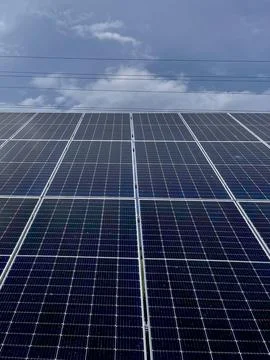 Solar Panel Installation Under Bright Skies in a Rural Area During the Dayt.. Stock Photos