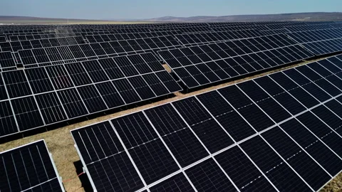 Solar panel installation in a vast field showcasing rows of photovoltaic modules Stock Footage 336068624