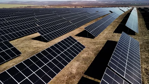 Solar panel installation in a vast field shows rows of photovoltaic modules Stock Footage 336069281