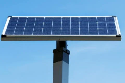 Solar panel installed in the top of a pole, over the blue sky Stock Photos