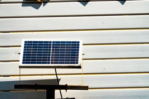 A solar panel is mounted on a wooden post Foto stock