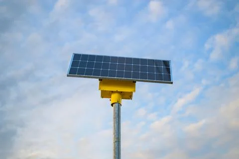 Solar panel mounted on yellow pole Stock Photos