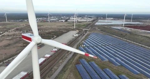 Solar panel park and wind turbine on an industrial site, called Kristal Solar Stock Footage 266312009
