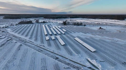 Solar panel park covered in snow during sunset Stock Footage 297055103