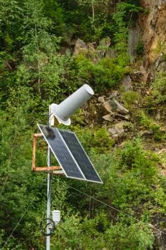 Solar panel powered communication station antenna with natural cliff and vege Stock Photos