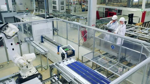 Solar panel production process with two inspectors observing it Stock Footage 168140185