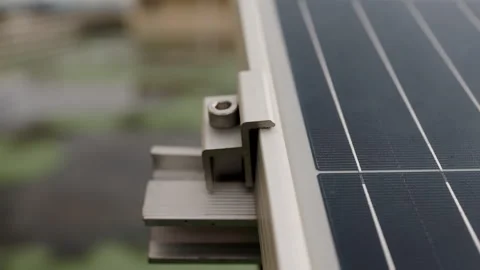 Solar panel rim mounting edge brackets or edge clip on solar frame and rail. Stock Footage 341793206