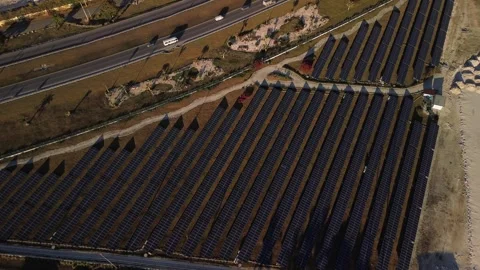Solar panel rows and highway aerial view. Photovoltaic panels farm. Dominican Stock Footage 268756021