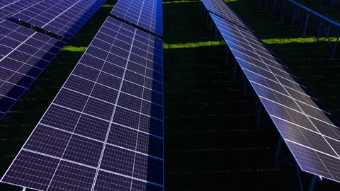 Solar panel rows casting shadows across grass, Bulgaria Stock Footage 340407840