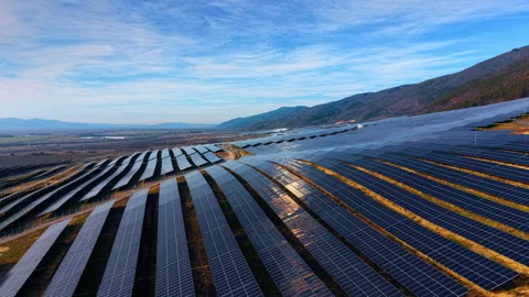 Solar panel rows on mountain hillside. Converging lines of photovoltaic arrays Stock Footage 336898861