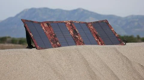 Solar panel in the sand against the background of mountains 스톡 사진