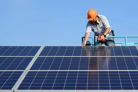 Solar panel station, Engineer installing solar panel at solar energy farm field Stock Photos